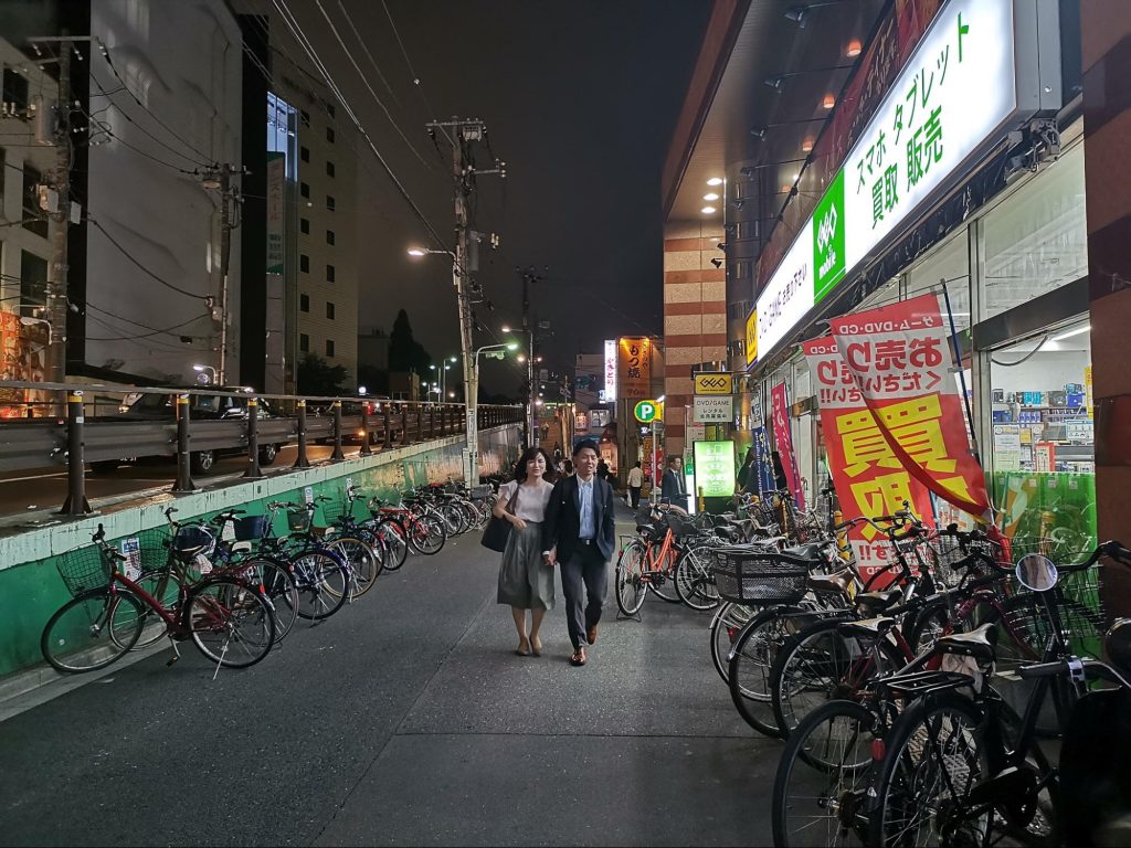Bikes lining the sidewalk of a Tokyo storefront