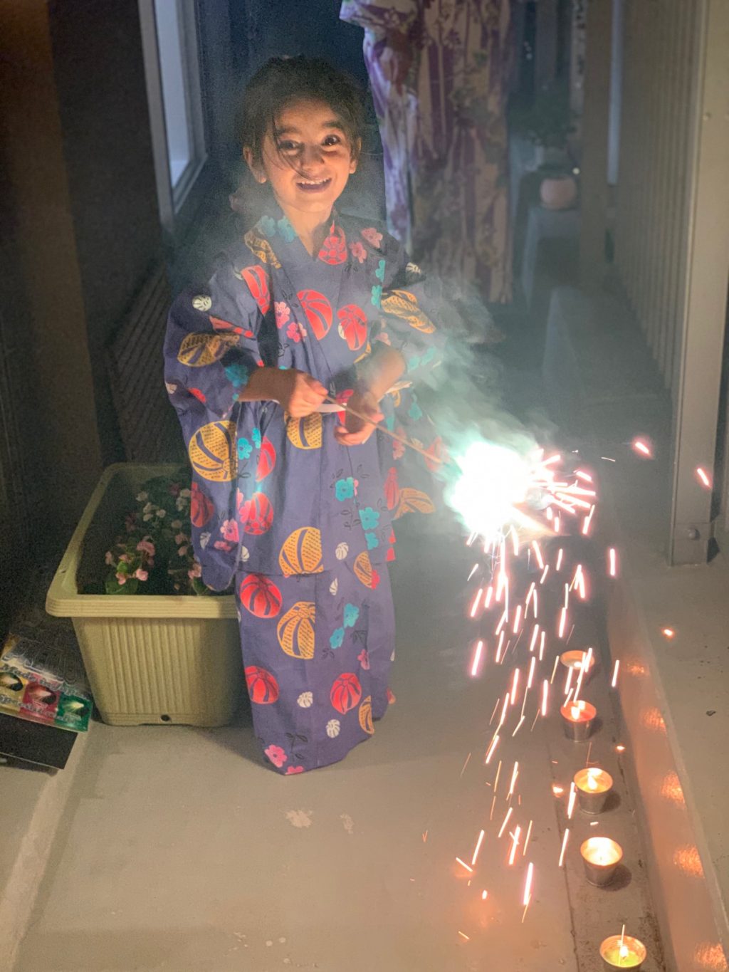 my daughter enjoying the home Natsu matsuri festival firecrackers